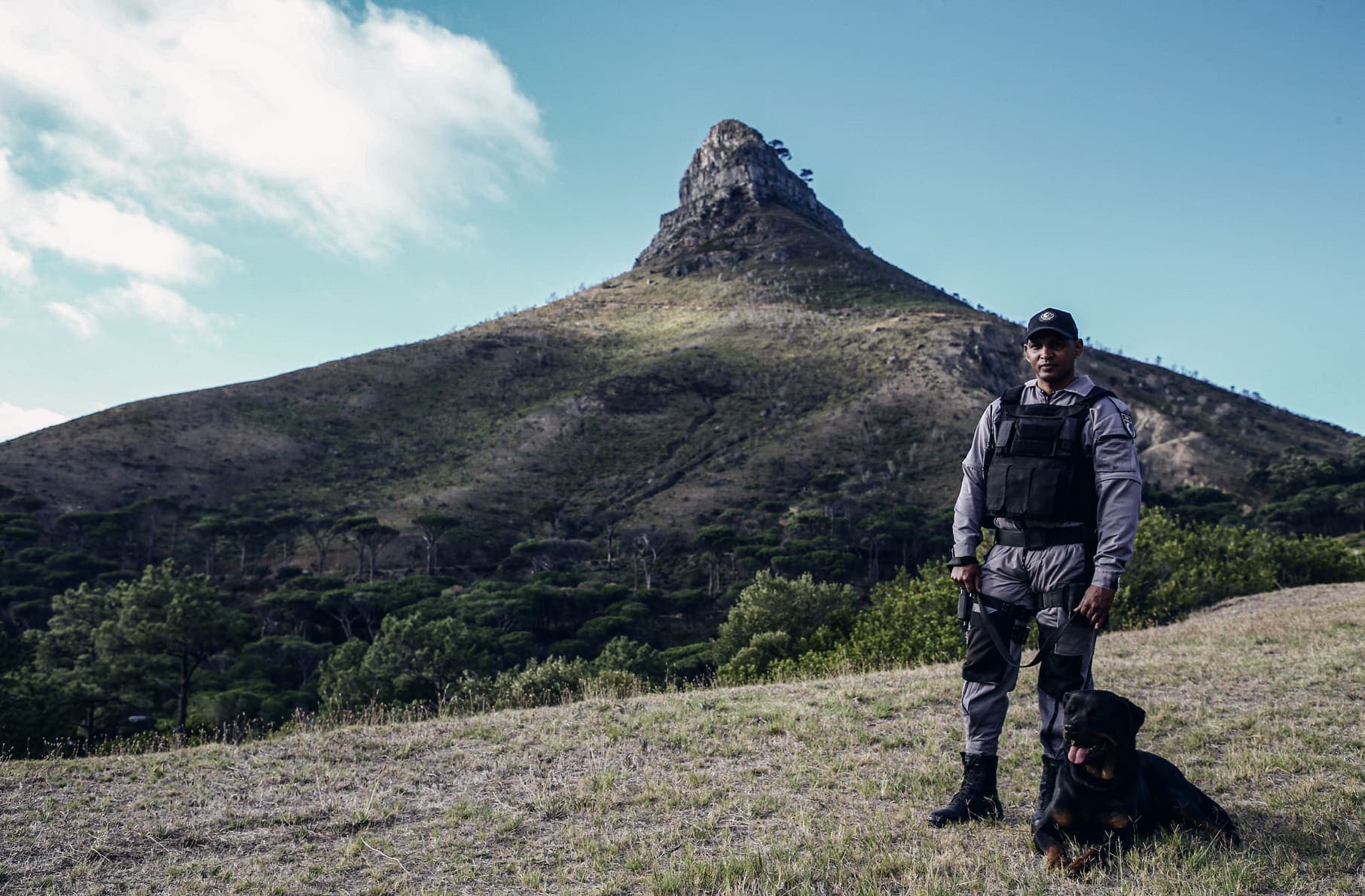 K9 handler with Rottweiler, Lion's Head behind