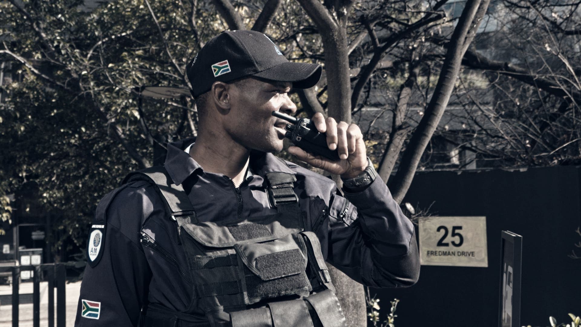 Tactical officer in plate carrier talking on radio